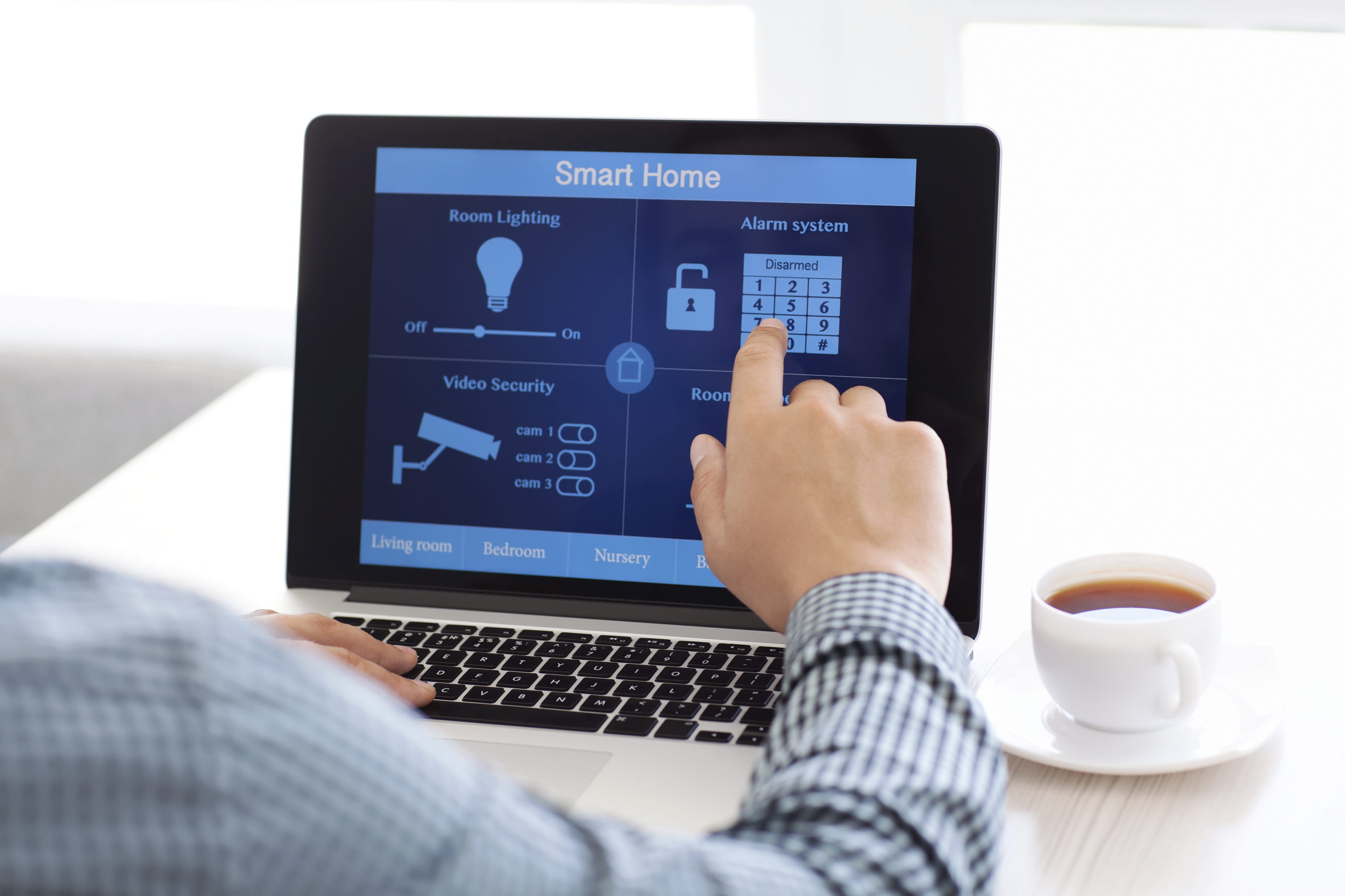 man sitting at a laptop with the program smart home on the screen